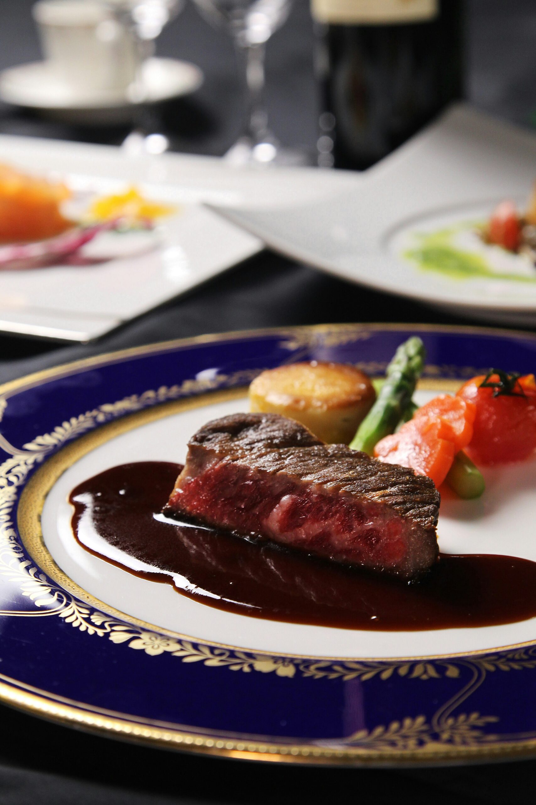 Delicious steak plated with sauce and sides.