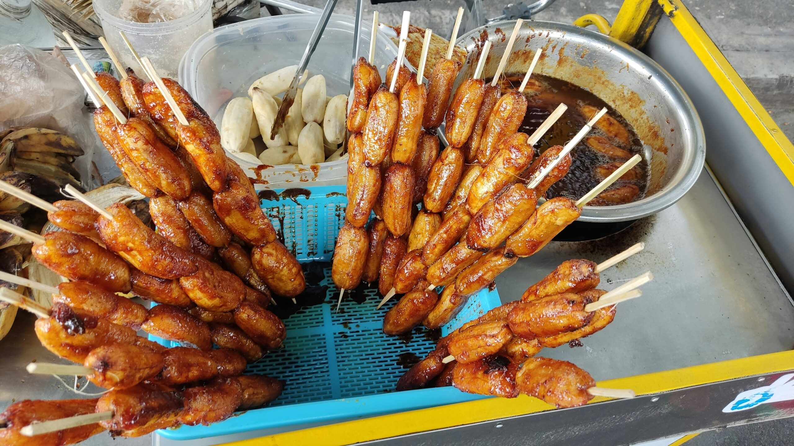 several skewers of food on a blue tray